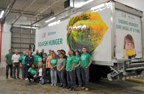 Citizens employees standing in front of the new refrigerated "Squash Hunger" Truck